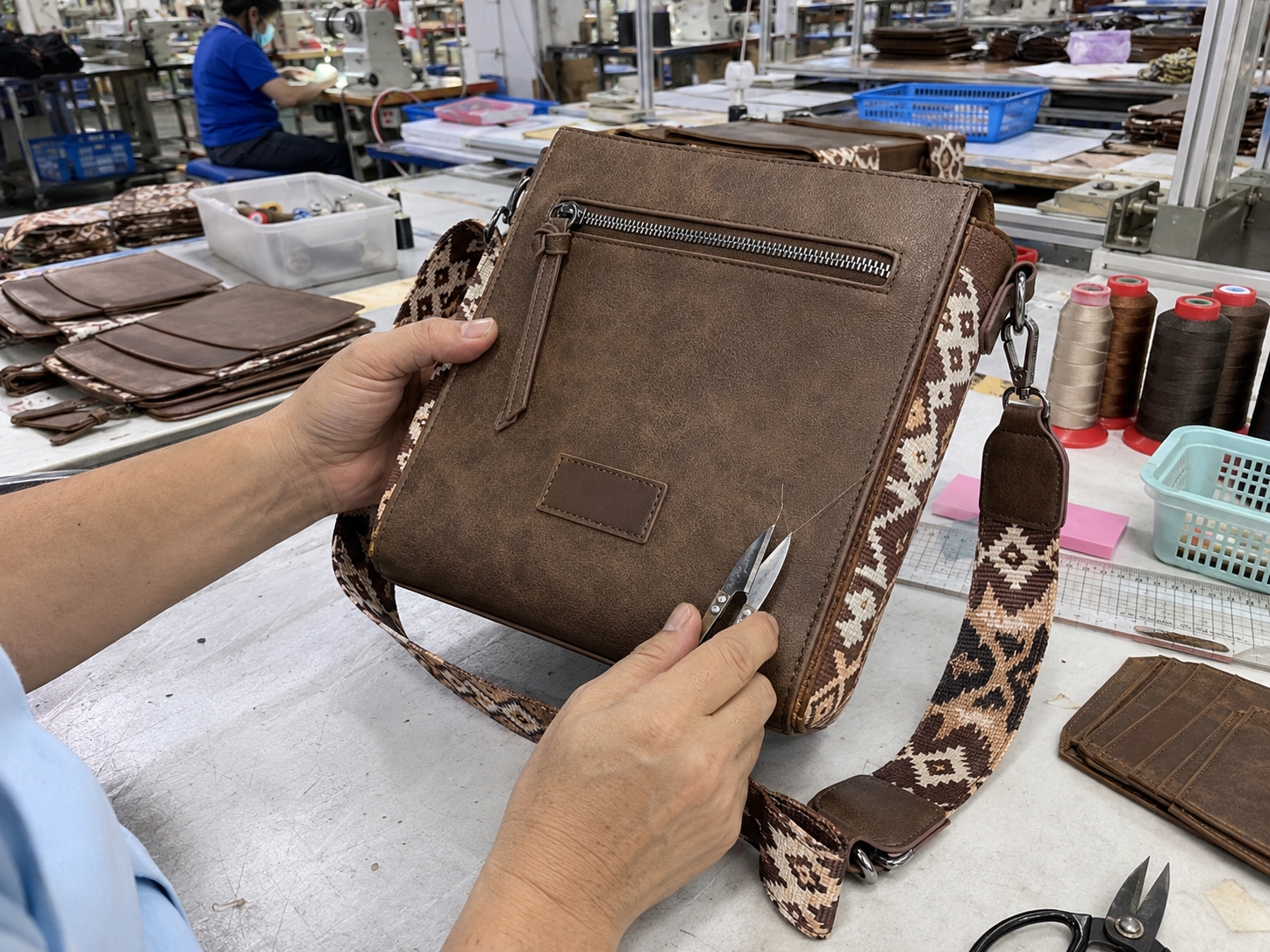 Stitching Quality Control Stitching quality control inspection on assembled Wrangler Aztec Crossbody Purse